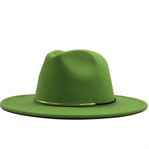 Detail of green wool fedora hat featuring a gold metal buckle and black decorative cord