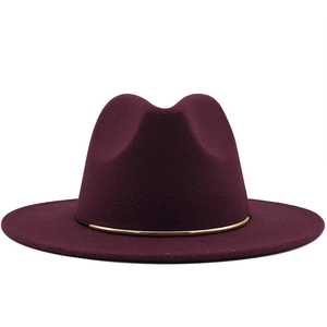 Close-up of wool fedora hat with elegant gold metal ring buckle in burgundy finish