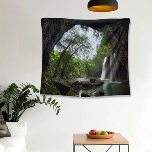 Detail of forest waterfall tapestry on a white wall in a modern living room