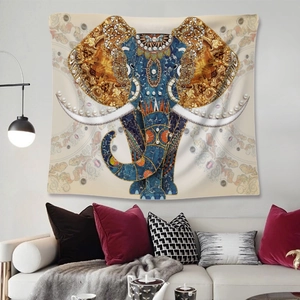 Detail view of Bohemian tapestry featuring an ornate elephant pattern hanging on a living room wall