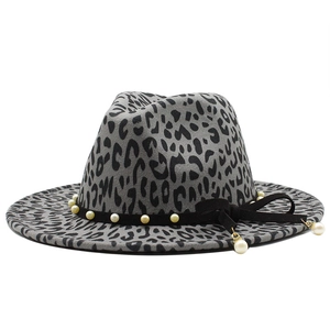 Detail of grey leopard print fedora hat featuring pearl accents and a black bow tie