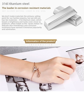 Detail of rose gold 316L titanium steel bracelet with diamond bow and flower charms