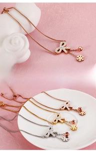 Macro detail of butterfly charm bracelet with cubic zirconia in gold, silver and rose gold