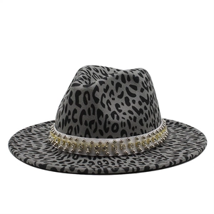 Detail of grey leopard print fedora hat featuring a studded ribbon and rhinestone trim