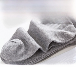 Close-up of light grey knit socks showing fine fabric texture and breathable cotton blend