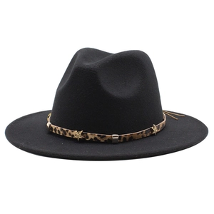 Detail of black wool fedora featuring leopard band and gold star metal ornaments