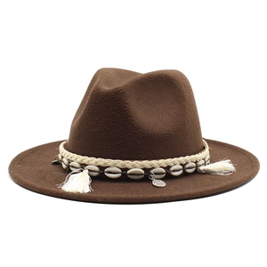 Detail of coffee brown wool fedora with bohemian shell band, weaving and white tassels