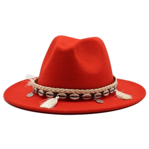 Detail of red wool felt jazz hat with bohemian woven band shell and tassel charms