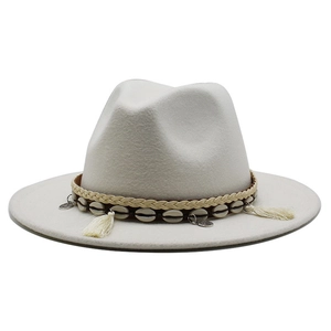 Detail of off-white wool fedora hat featuring bohemian shell and tassel headband decorations