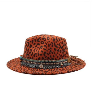 Detail of leopard print fedora hat with ethnic woven band, tassels and coin pendant