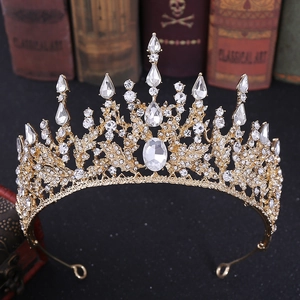 Detailed close-up of Baroque gold bridal crown with crystals on vintage books