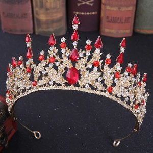 Detailed close-up of Baroque gold crown with red crystals and white rhinestones