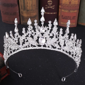 Macro shot of silver bridal tiara with rhinestones over vintage books background