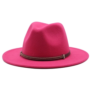 Detail of rose red wool fedora hat featuring a brown leather band and metal bead accents