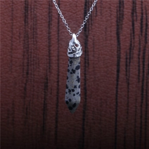 Macro shot of Dalmatian Jasper hexagonal stone pendant on a silver metal chain