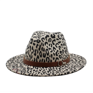 Close-up of leopard print fedora hat with brown leather band and metal buckle detail