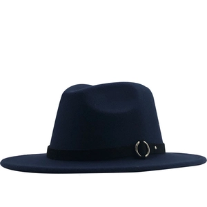 Detail of navy blue wool fedora hat featuring a black fabric band and silver metal ring