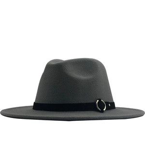 Detail of dark grey wool fedora hat featuring flat brim and silver ring ornament
