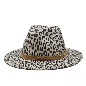 Detail of leopard print wool fedora featuring a brown band with gold bead accents