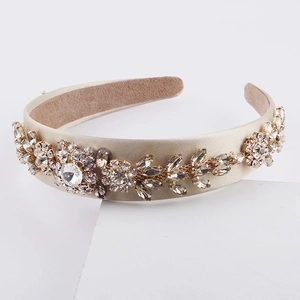 Baroque champagne gold headband with intricate floral crystals and diamonds on white stand