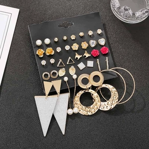 Detailed set of 30 pairs of gold-tone floral and pearl stud earrings on black card
