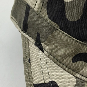 Detailed close-up showing high-density double stitching on jungle camouflage canvas fabric
