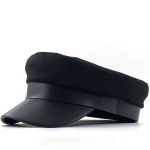 Classic black newsboy cap in wool and leather seen from a professional 45-degree angle