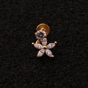 Macro shot of gold zircon flower cartilage stud with stainless steel internal threading