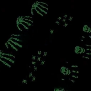 Luminous glow-in-the-dark skull and bone prints on knit gloves for children