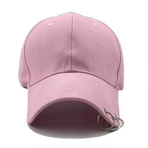 Pink cotton baseball cap featuring three silver metal rings on the brim in a street style
