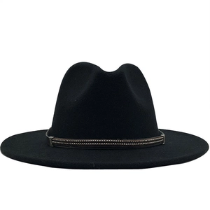 Detail of black fedora hat with brown metal studded band and wide flat brim style