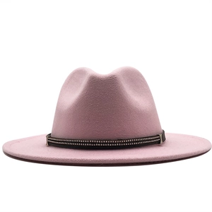 Detail of pink wool fedora hat featuring black band with silver metal studs decoration