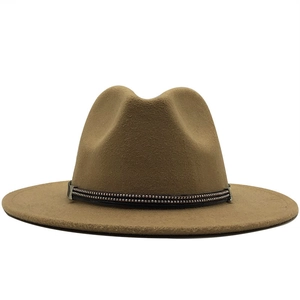 Macro detail of camel wool fedora hat featuring black punk zipper band and silver rivets