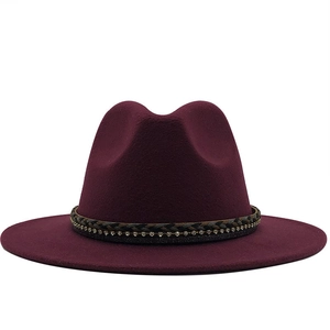 Detail of wine red wool fedora hat featuring a gray braided band with sparkling rhinestones
