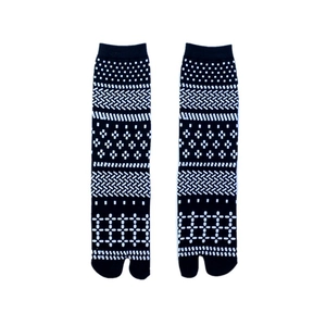 Detail of black tabi socks featuring white geometric patterns and unique split-toe design