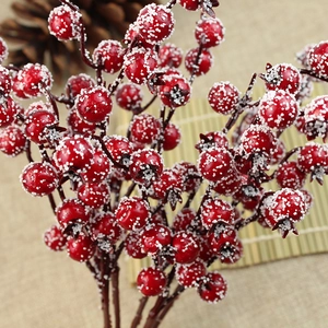 Close-up of artificial red berries with artificial snow for Christmas tree decoration