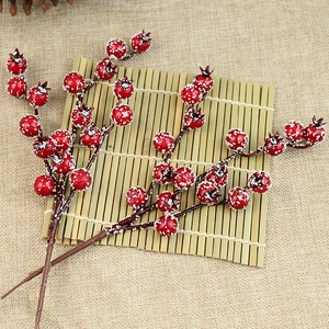 Artificial red berries with artificial snow for Christmas tree and home decoration