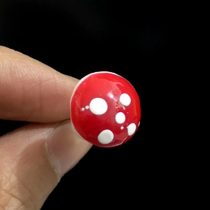 Macro shot of miniature red and white spotted foam mushrooms for DIY crafts