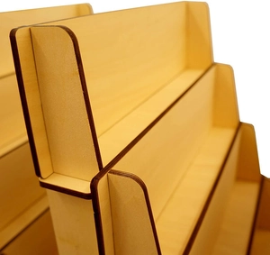 Detail view of the layered wooden display stand showing natural wood grain and edge finish