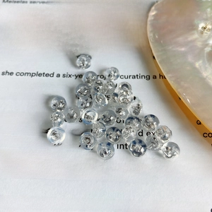 Macro shot of 925 silver ear backs with silicone covers on an English book page