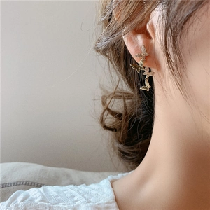 Close-up of elegant gold butterfly earrings with sparkling cubic zirconia on model