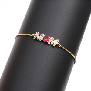 Golden MOM charm bracelet with red gemstone and colorful pavé stones on box chain
