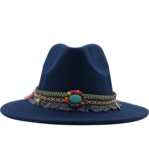 Detailed view of navy felt hat featuring ethnic woven band and turquoise gemstone