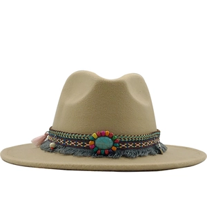 Detail of wool fedora hat with ethnic woven band, turquoise bead and blue fringe tassels