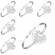 Close-up of silver heart bracelet engraved with romantic quotes for wife from husband