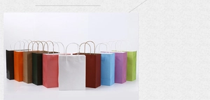 Group of colorful kraft paper shopping bags with handles shown in various vibrant shades