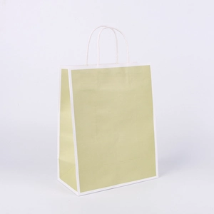 Detail shot of a light green kraft paper shopping bag with white handles and border
