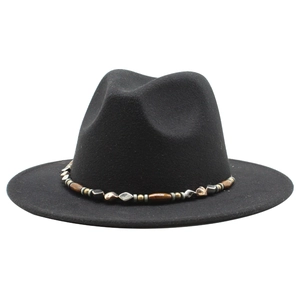 Close-up of black fedora wool hat with unique vintage beaded ethnic style chain strap