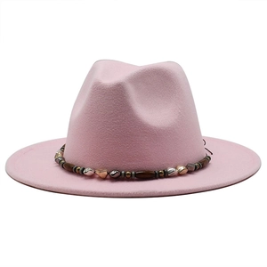 Detail of pink wool fedora with decorative ethnic beaded band and metallic accents