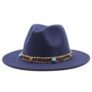 Detail of navy blue wool fedora with woven band, turquoise beads and gold rivets